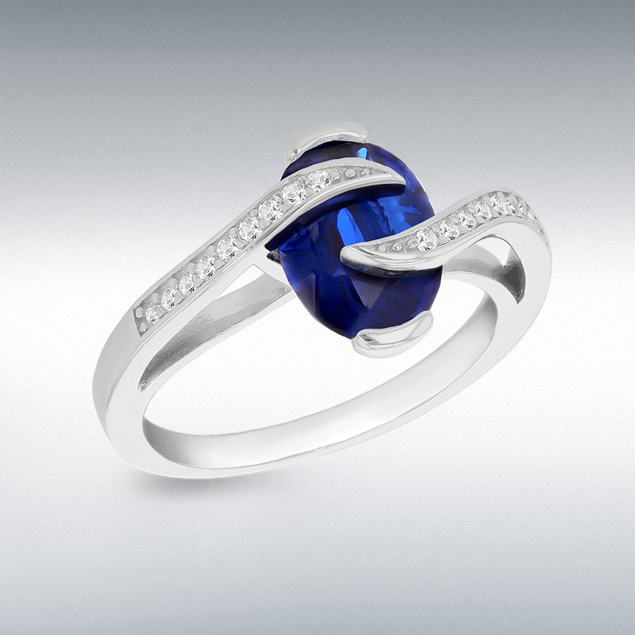 Sterling Silver Rhodium Plated Blue Oval Synthetic Spinel with White Round CZs Crossover Ring