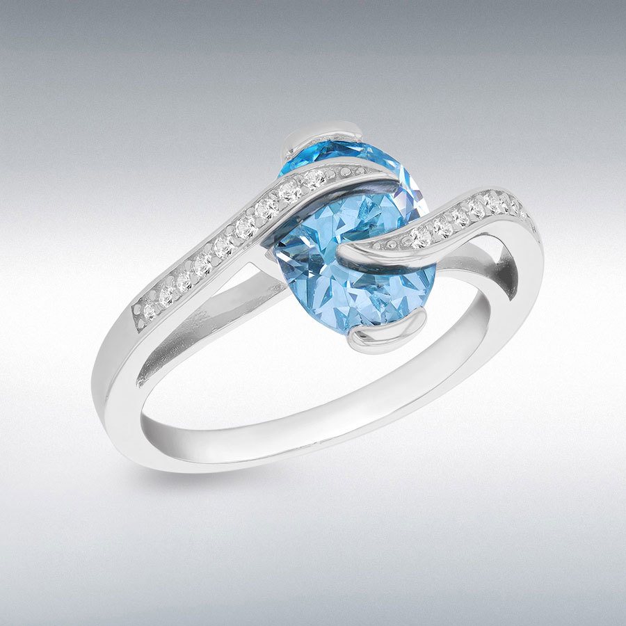 Sterling Silver Rhodium Plated Light Blue Oval CZ with White Round CZs Crossover Ring